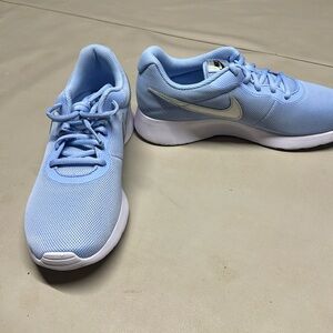 Brand new Nike tennis shoes. Light blue.  Never worn